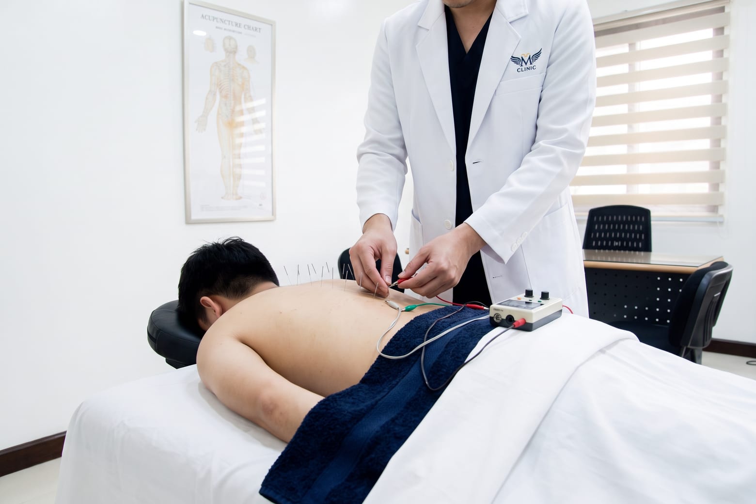 A practitioner adjusting an electroacupuncture lead clipped to a needle in a patient’s back.